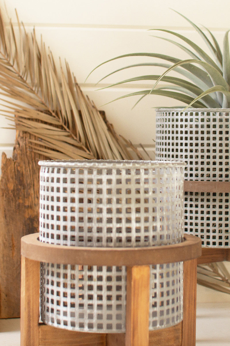 SET OF THREE WOVEN METAL PLANTERS WITH WOOD STANDS
